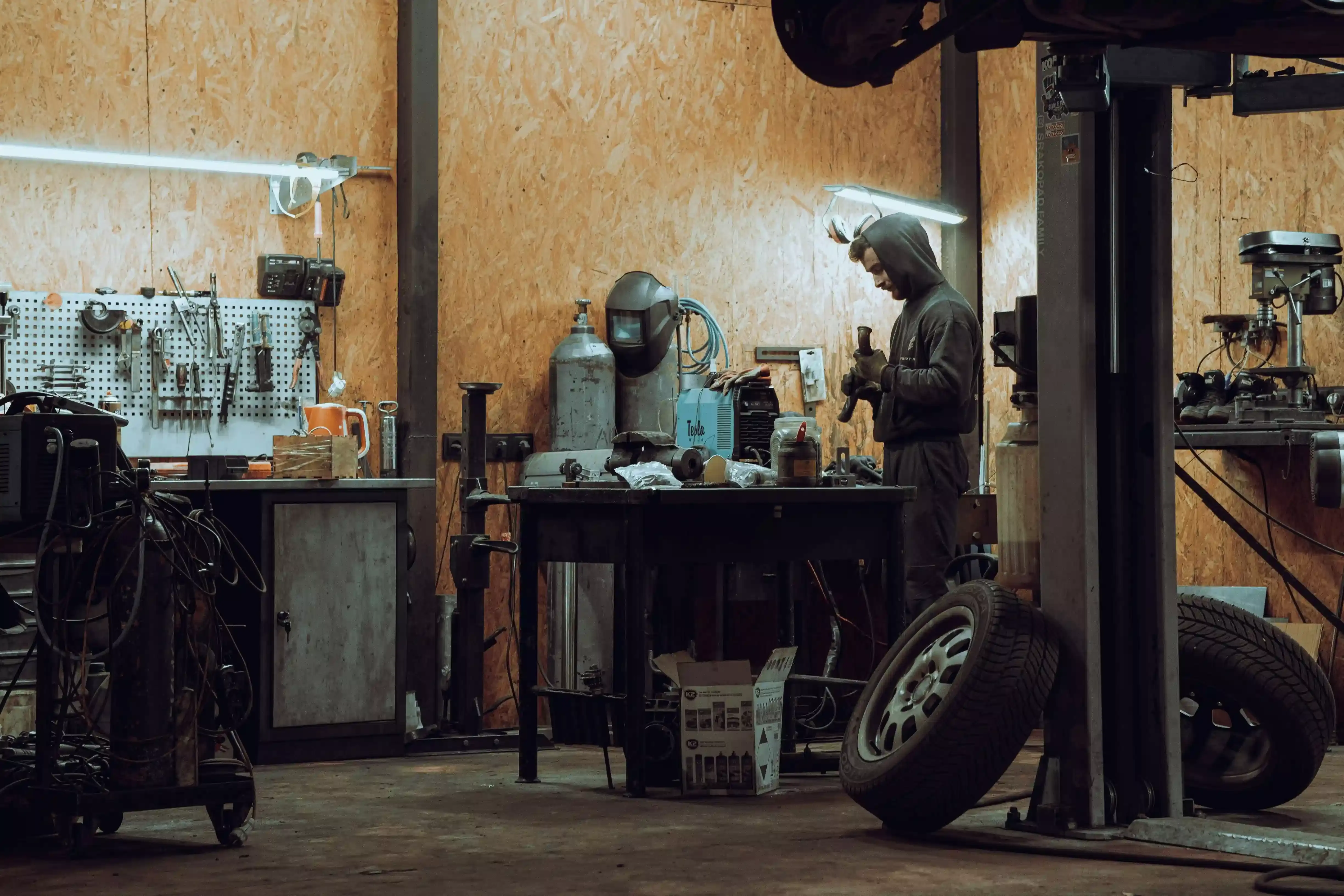 Technician working on a vehicle in a repair facility